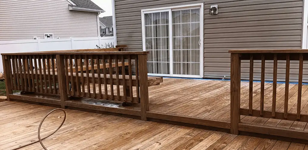 Deck sealing service protecting a backyard wood deck and railings in New Haven, CT