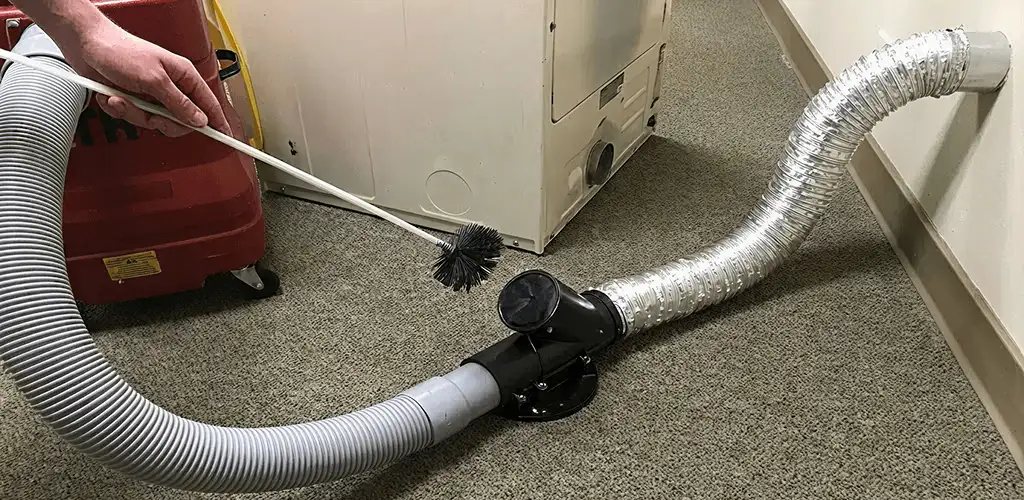 Dryer vent cleaning service removing lint from a dryer duct connection in New Haven, CT