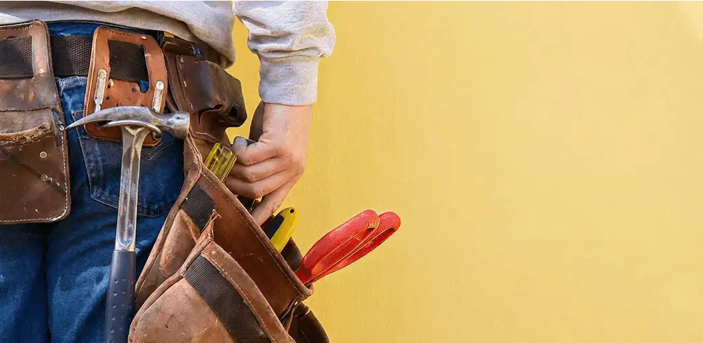 Handyman with tool belt ready for home repairs and maintenance in New Haven, CT