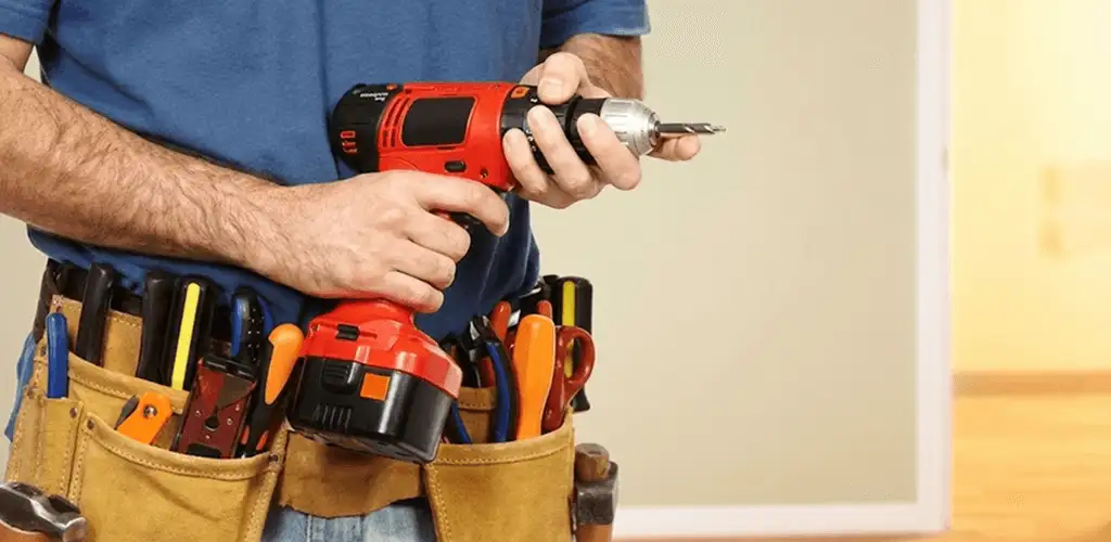 Handyman holding a power drill for home repairs and installations in New Haven, CT