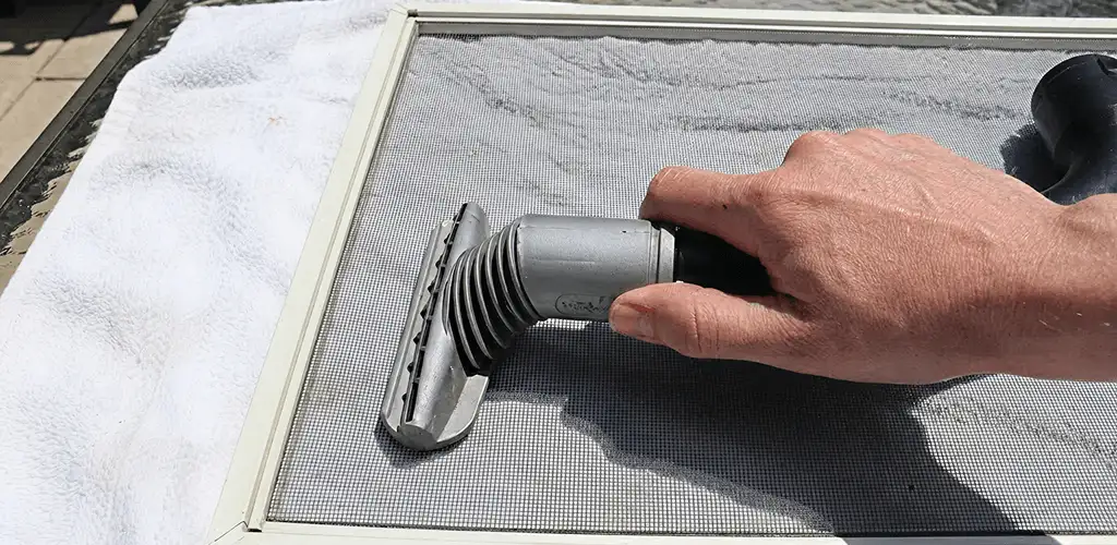 Window screen repair cleaning and fixing a damaged screen mesh in New Haven, CT
