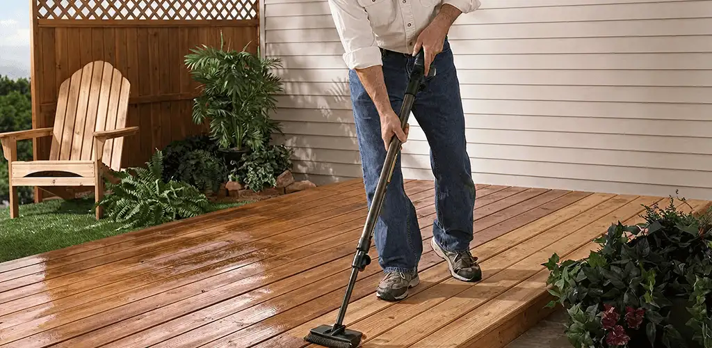 Deck staining service applying stain to a backyard wood deck in New Haven, CT
